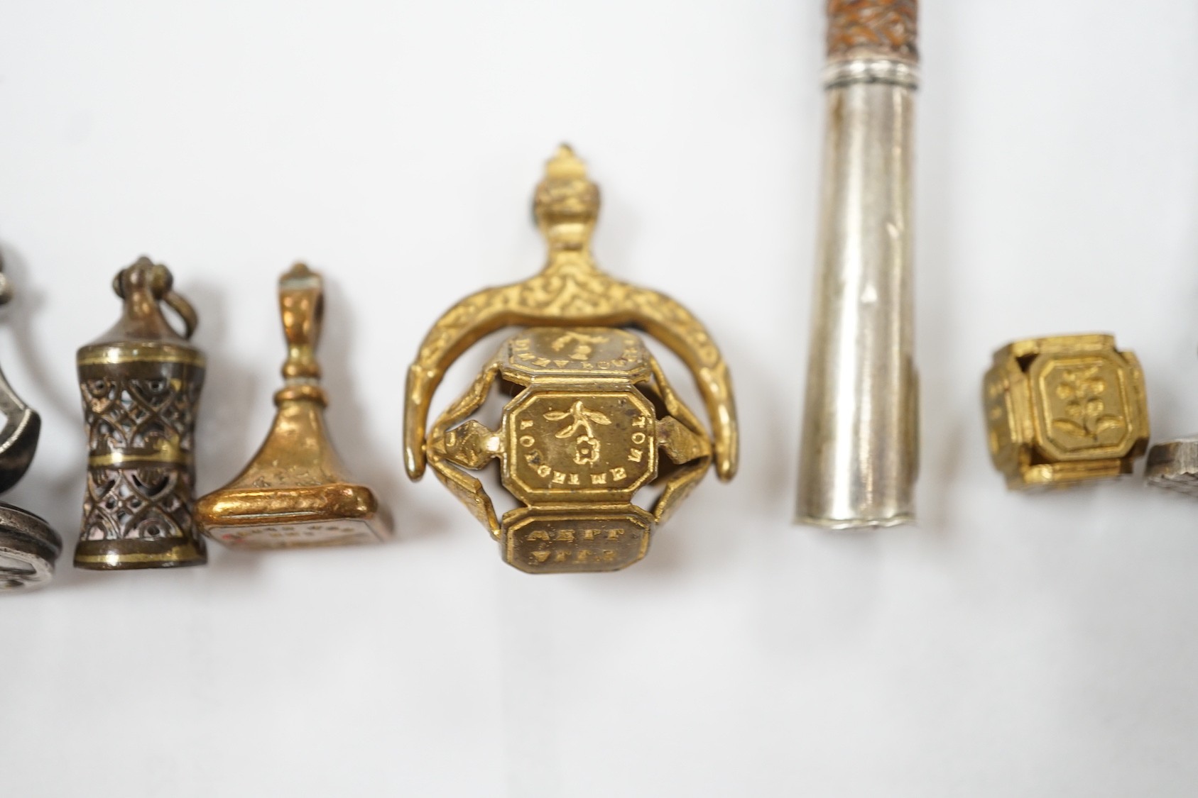 A group of twenty-five steel, gilt metal or nickel fob or desk seals, mostly 19th-century, including a steel swivel seal, a seal with boxwood finial modelled as a hand holding a ball and a nickel multi seal
